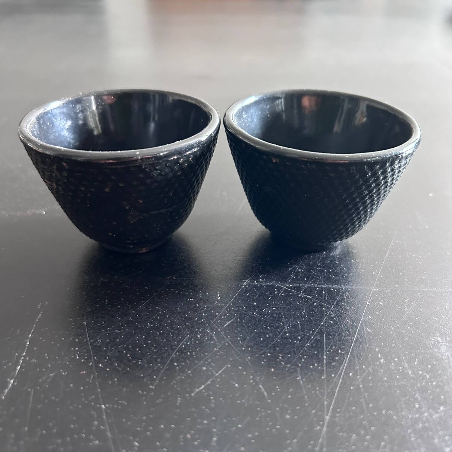 2 cast iron tea cups