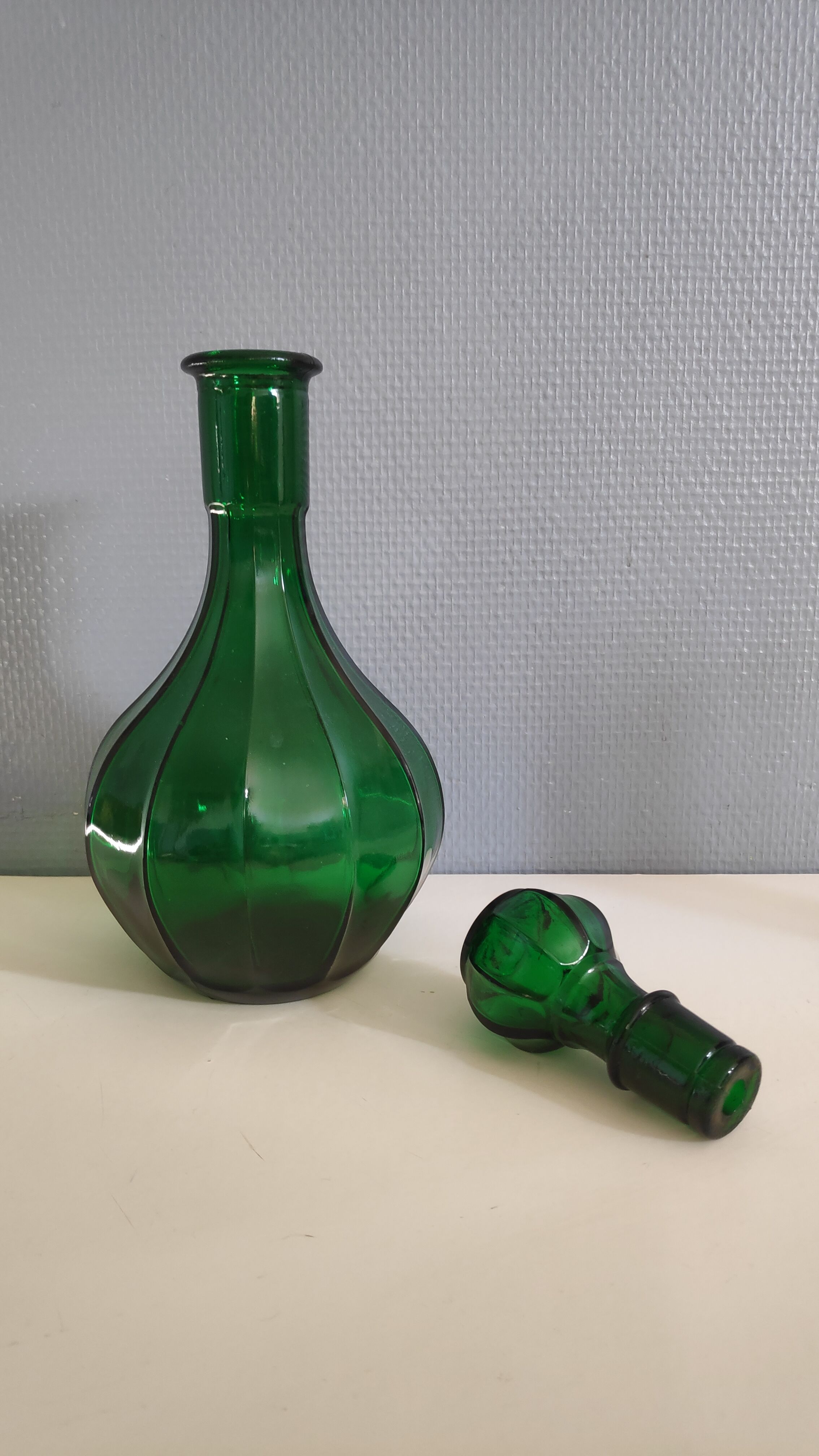 Old green carafe with ribbed lines