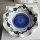 Small hand-painted earthenware salad bowl with garland of blue flowers, mark below