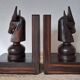 Pair of vintage wooden bookends with stylised horse heads.