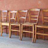 Set of 5 mismatched straw chairs.
