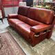 living room in patinated leather and brass from the 80s