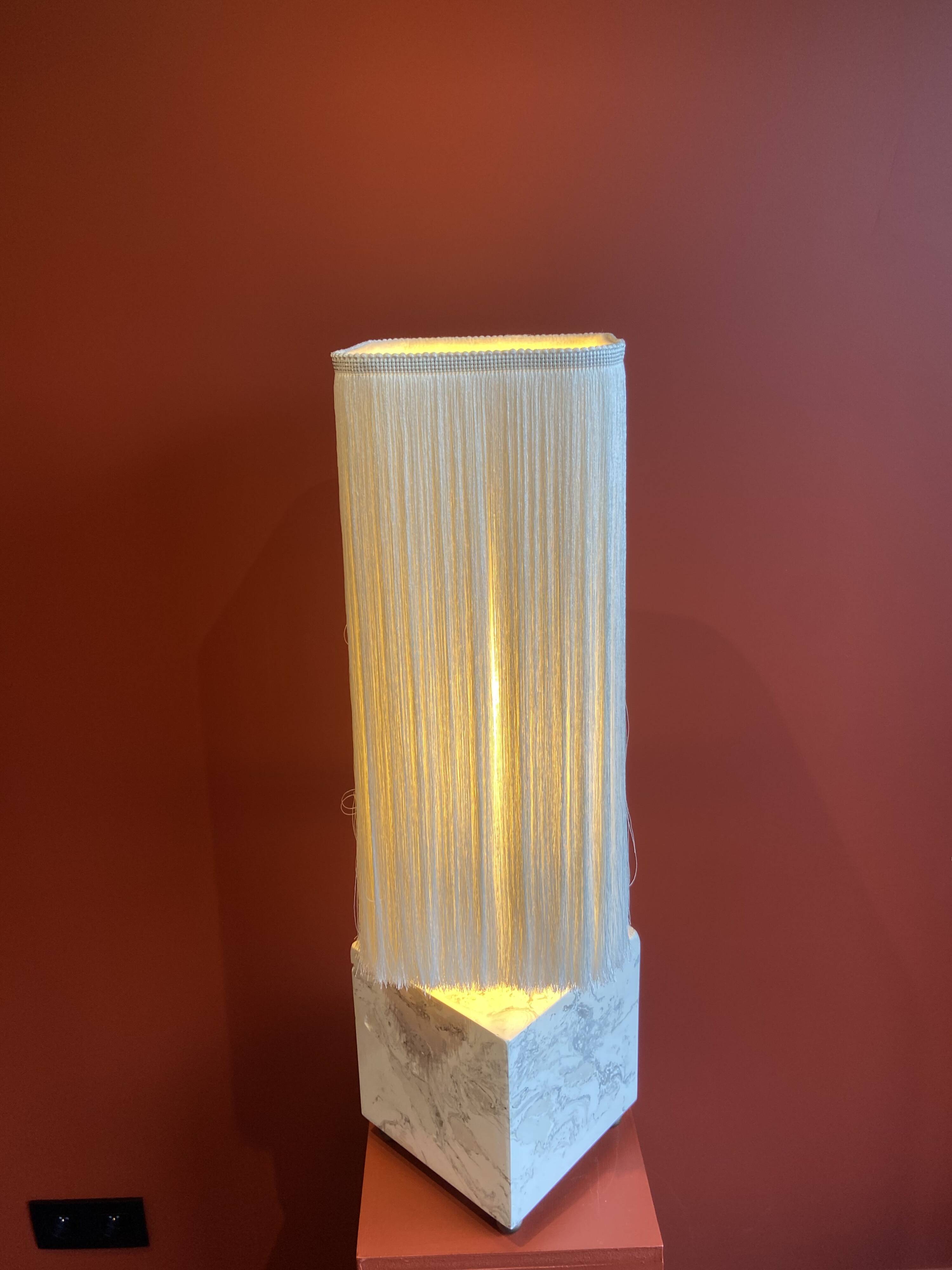 Beige marble stucco base, Houles white ecru fringed lampshade.