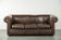 Set of a smooth chesterfield sofa and armchair with a timeless English look