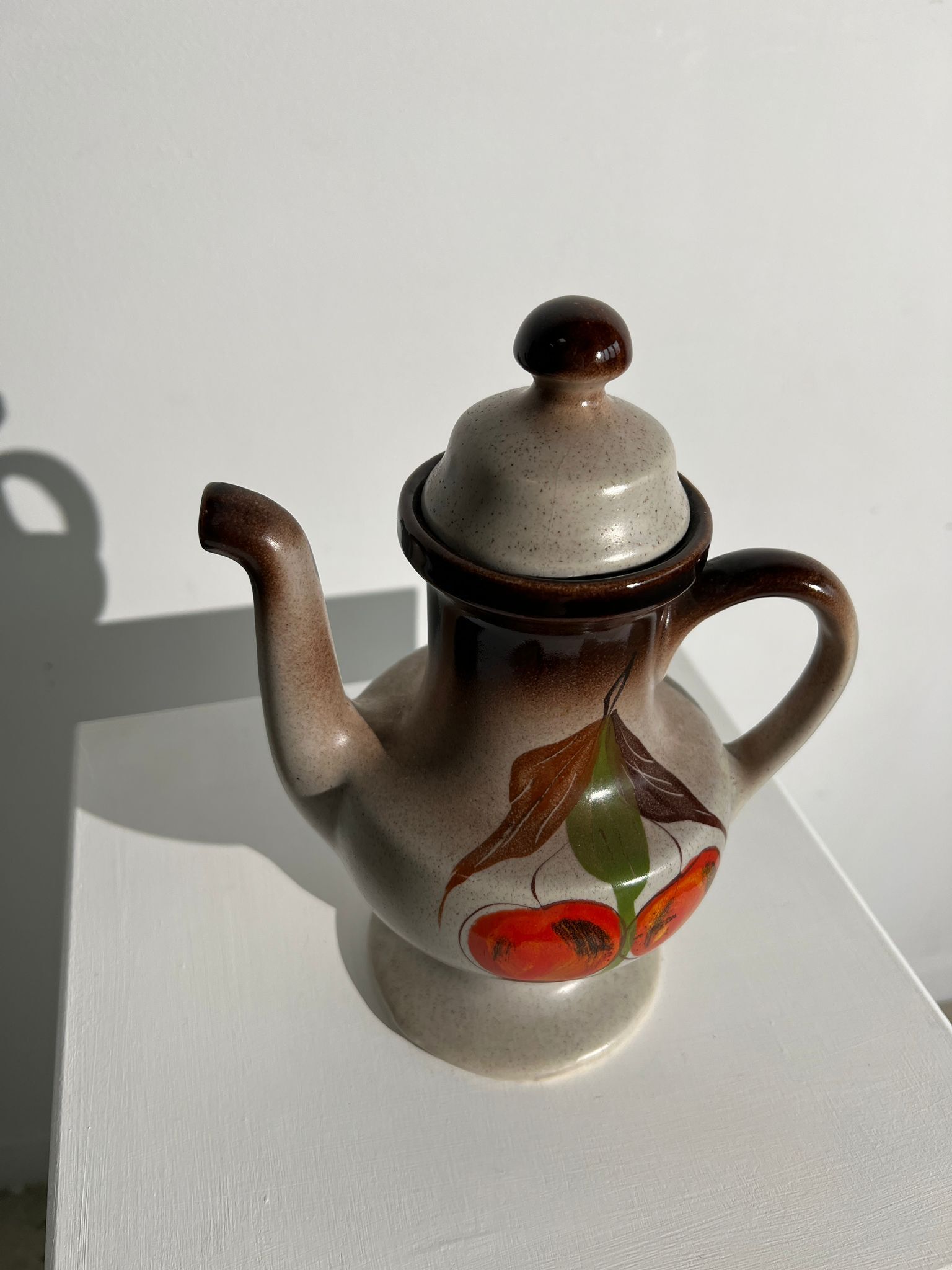 Vintage stoneware teapot with flower and fruit patterns