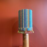 "Stoneware Bottle Lamp" with a multicoloured blue lampshade handwoven in India.