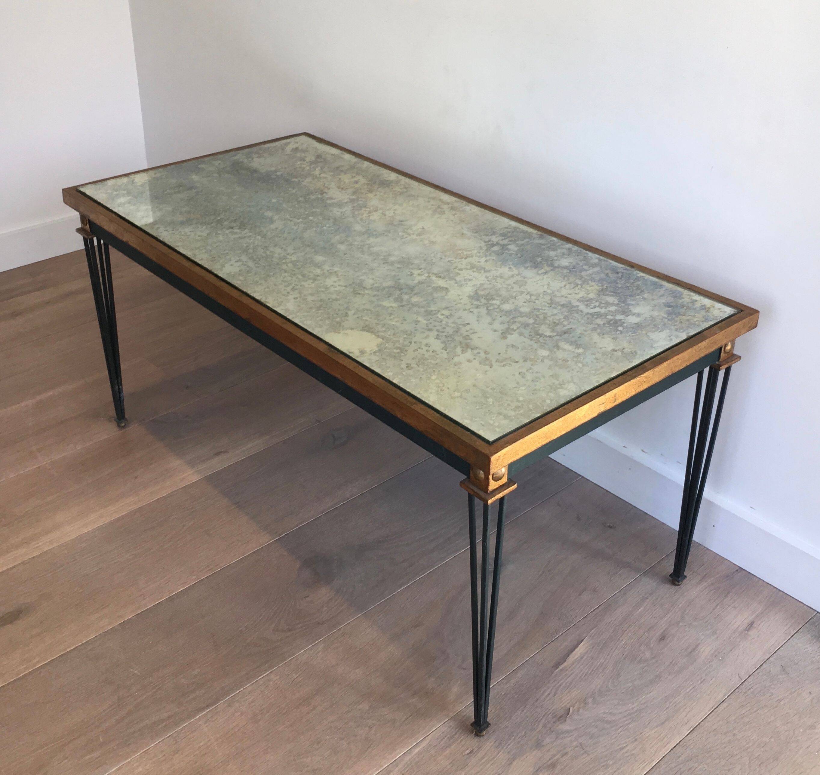 Patinated and gilded steel coffee table in the style of Jacques Quinet.