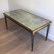 Table basse en acier patiné et doré dans le goût de Jacques Quinet