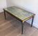 Table basse en acier patiné et doré dans le goût de Jacques Quinet