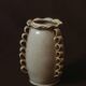 White glazed stoneware vase decorated with raised ribbons.