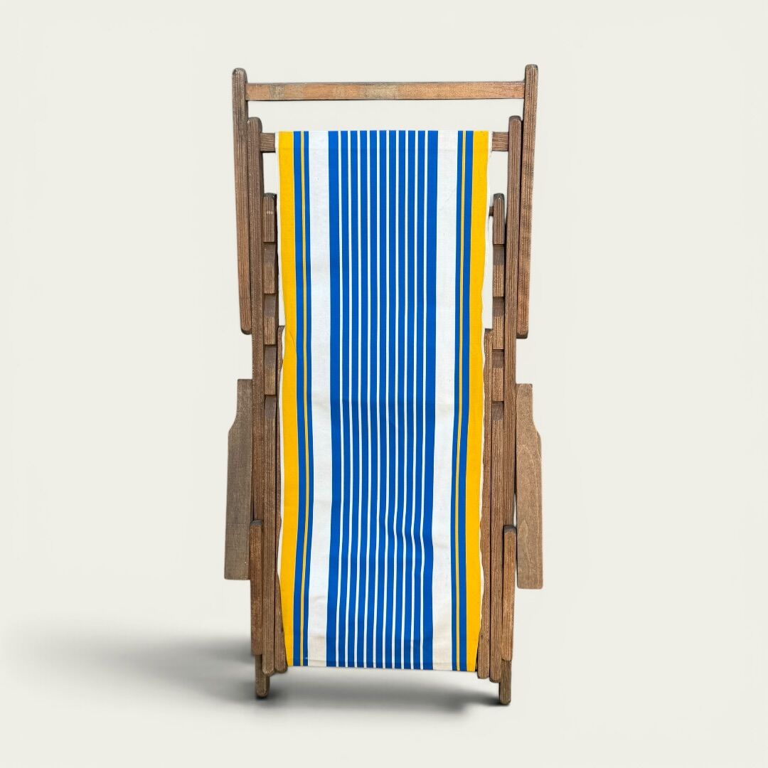 Vintage deck chair with blue and yellow striped fabric, original patina.