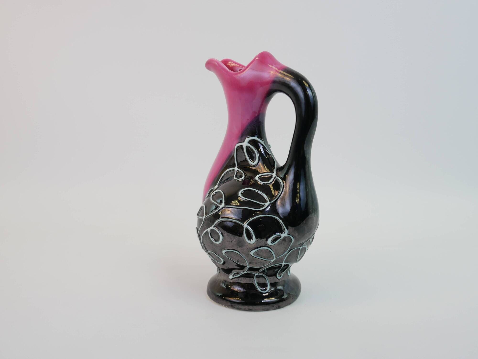 Black and pink Vallauris carafe with white relief patterns