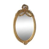 Oval mirror in Louis XVI style in wood and gilded stucco.