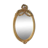 Oval mirror in Louis XVI style in wood and gilded stucco.