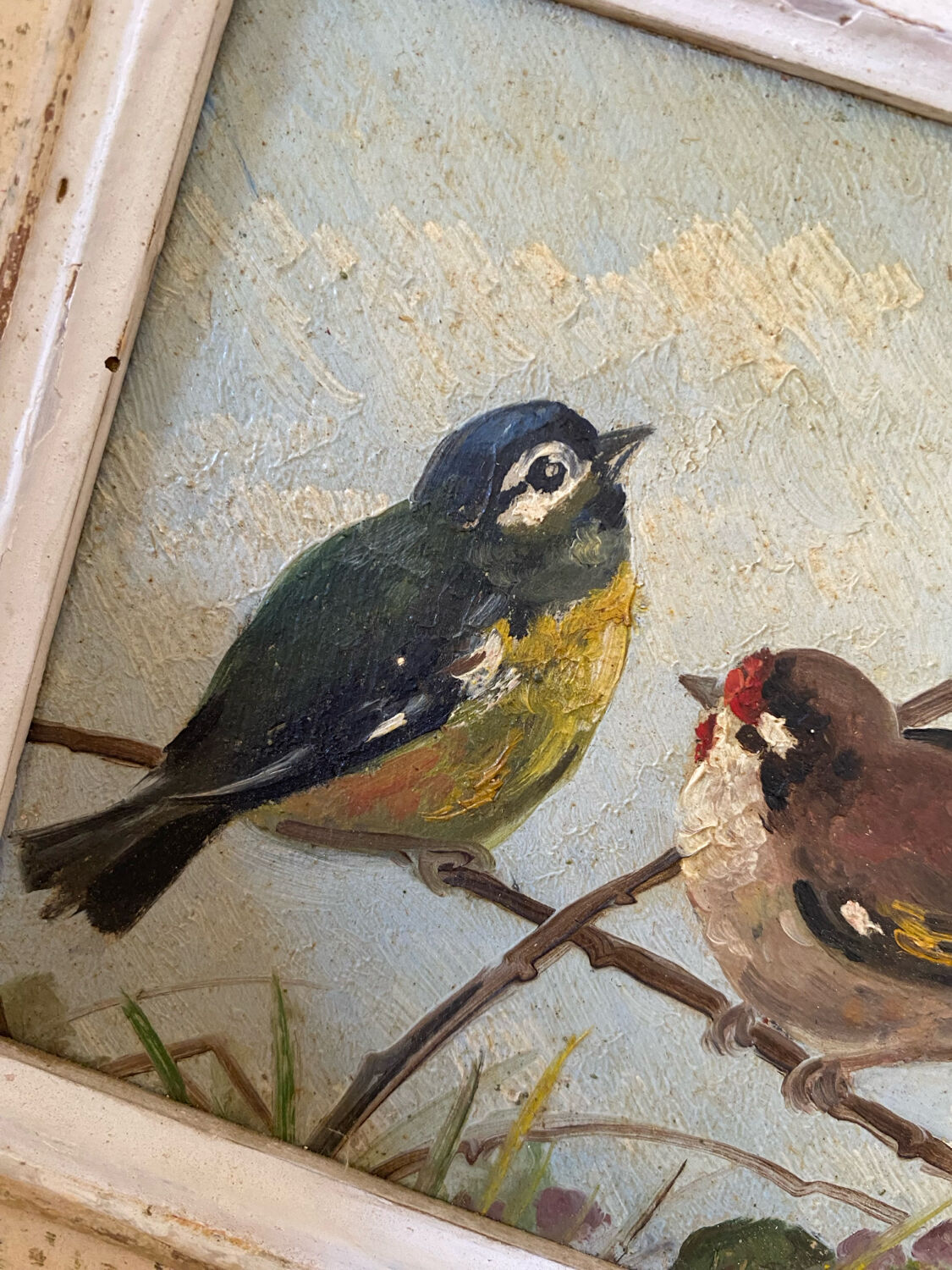 Vintage painting on panel of 3 tits on a branch.