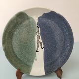 Glazed ceramic plate representation man between two lands unknown signature