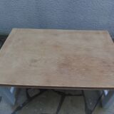 Coffee table with pearl grey legs and a wooden top.