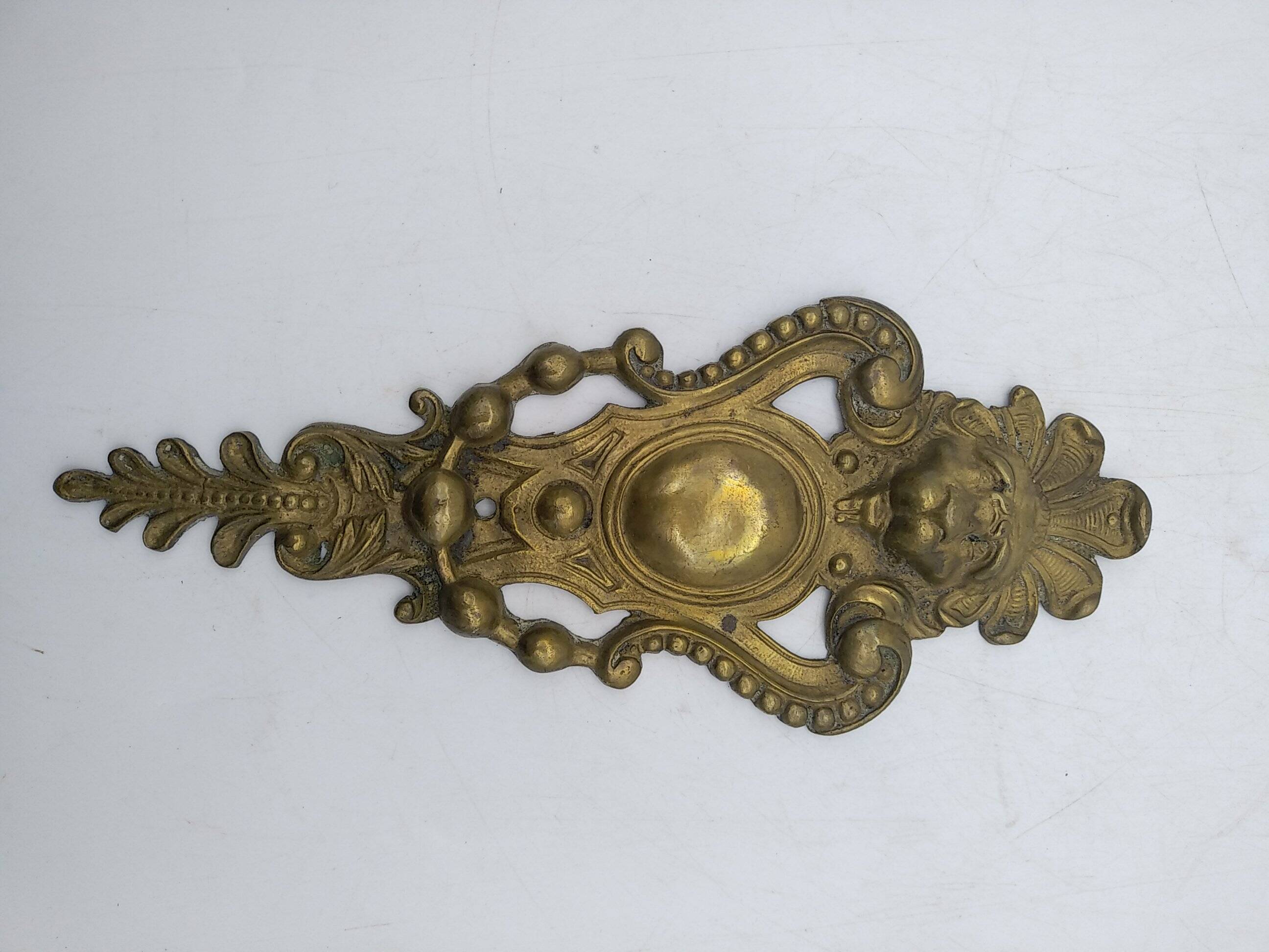 Brass lion head. Furniture decoration, leftover knocker or large nail cover?