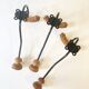 Trio of antique wooden and metal coat hooks