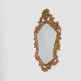 French Rococo or Baroque style facet-cut crest mirror in gilded carved wood