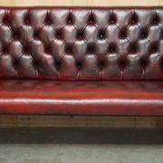 Victorian Chesterfield leather sofa with carved lion heads.
