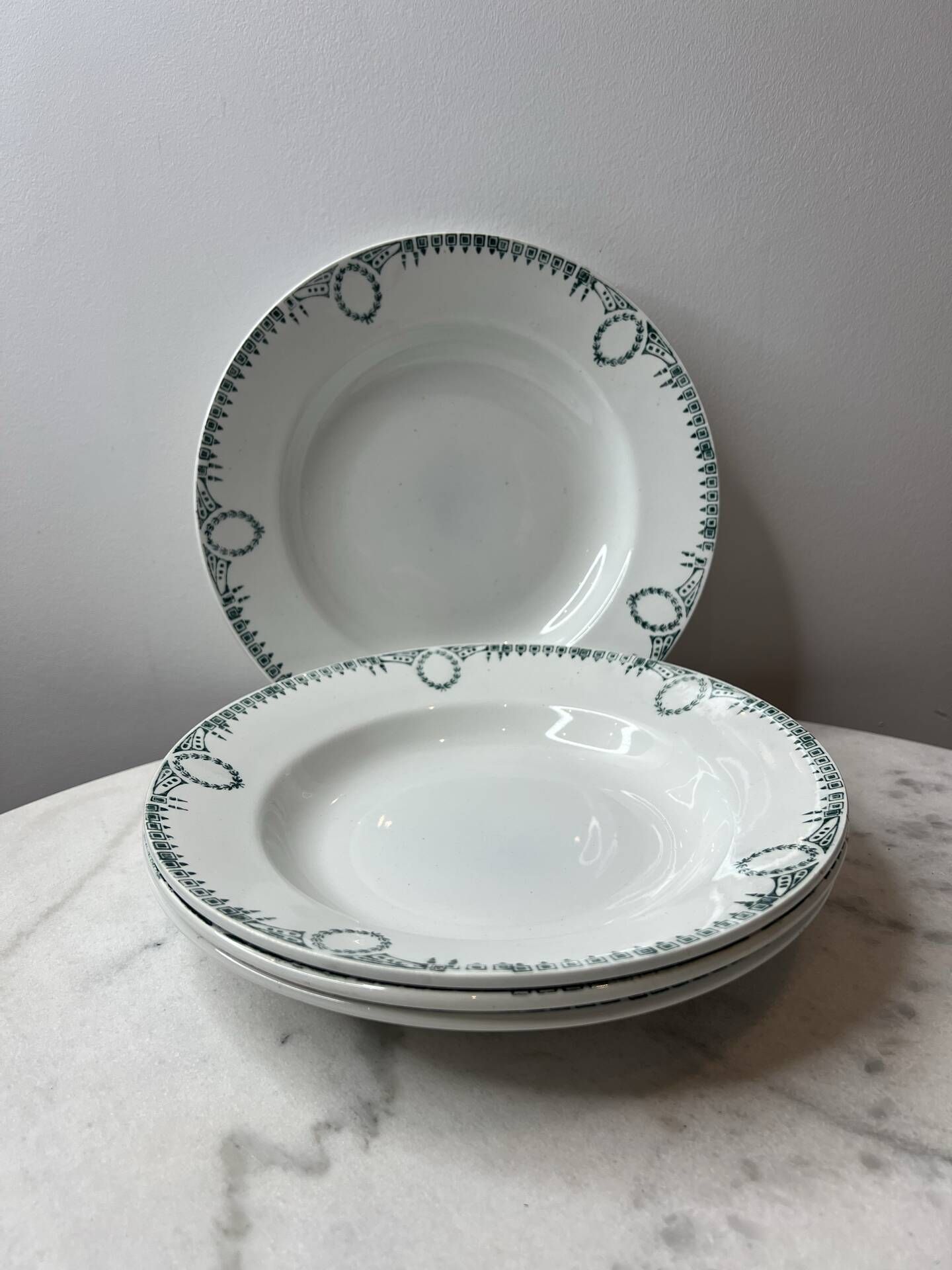 Set of 4 deep plates from Saint Amand with laurel wreath decoration.