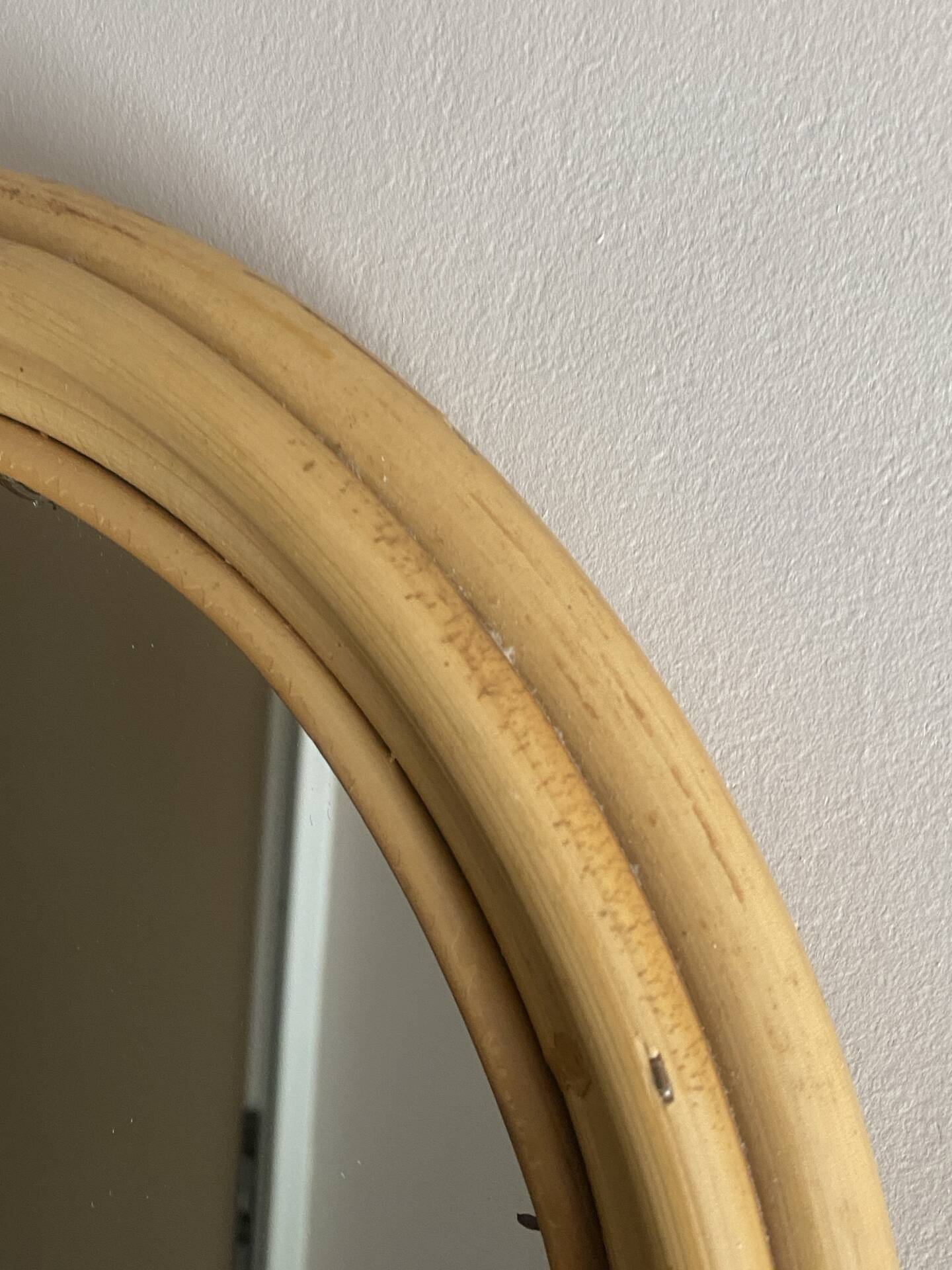 Round mirror from the 1960s with a frame made of rattan and metal.