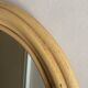 Round mirror from the 1960s with a frame made of rattan and metal.
