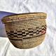 Antique basket with ethnic lid with black/brown and red décor