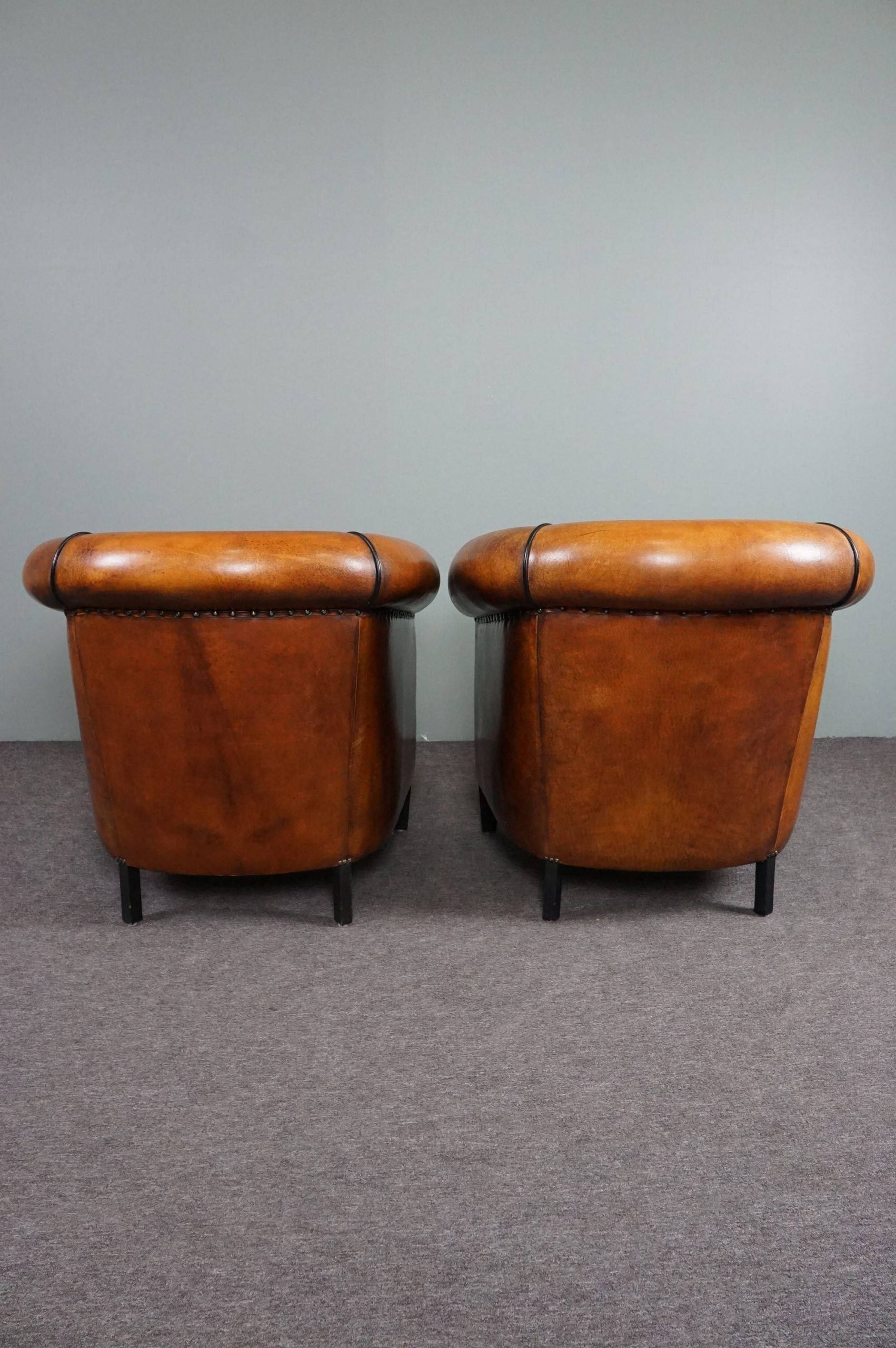 Set of 2 club chairs in black piping sheep leather