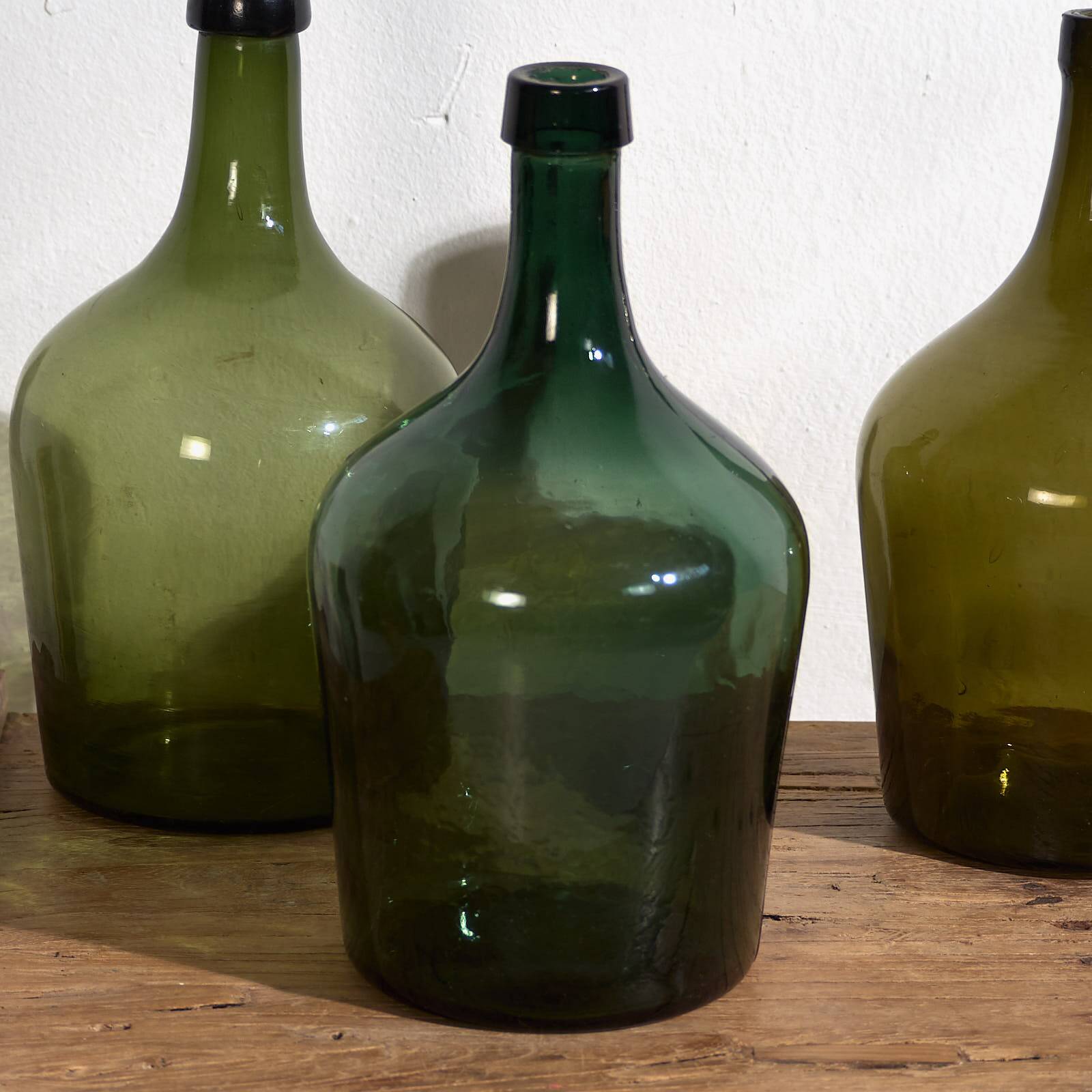 Antique green demijohns (circa 1920). Set of 3 pieces
