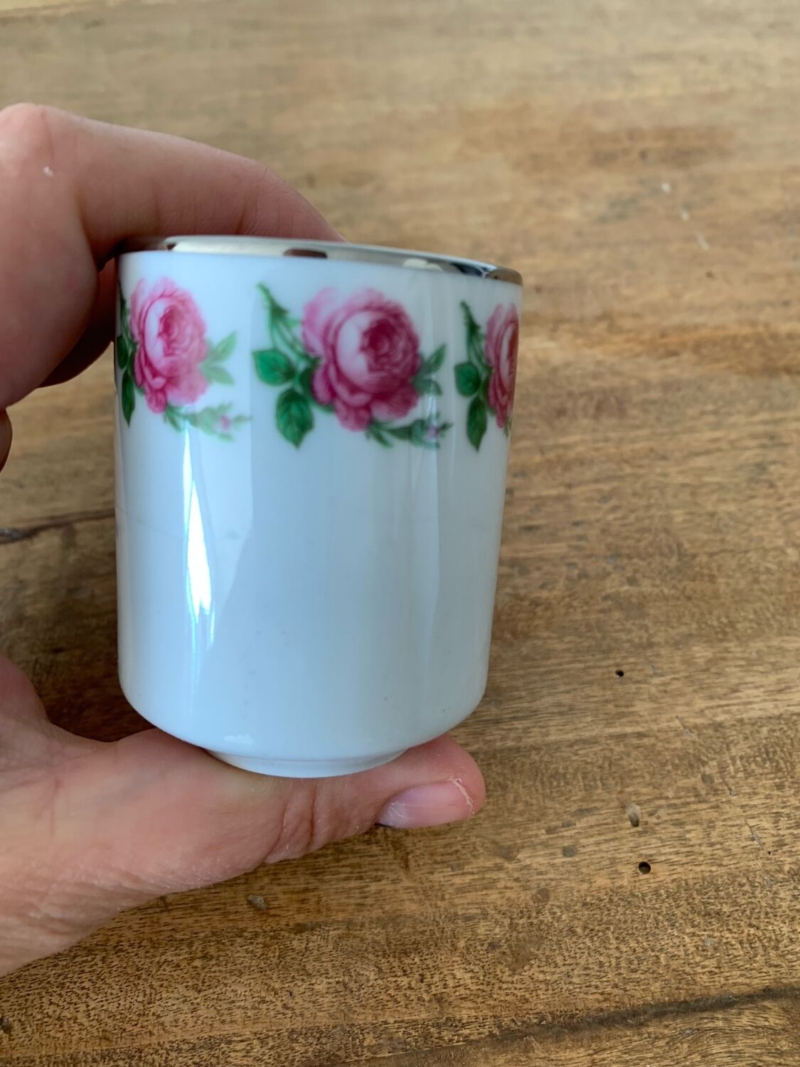 2 small porcelain cups and their pewter cup holders