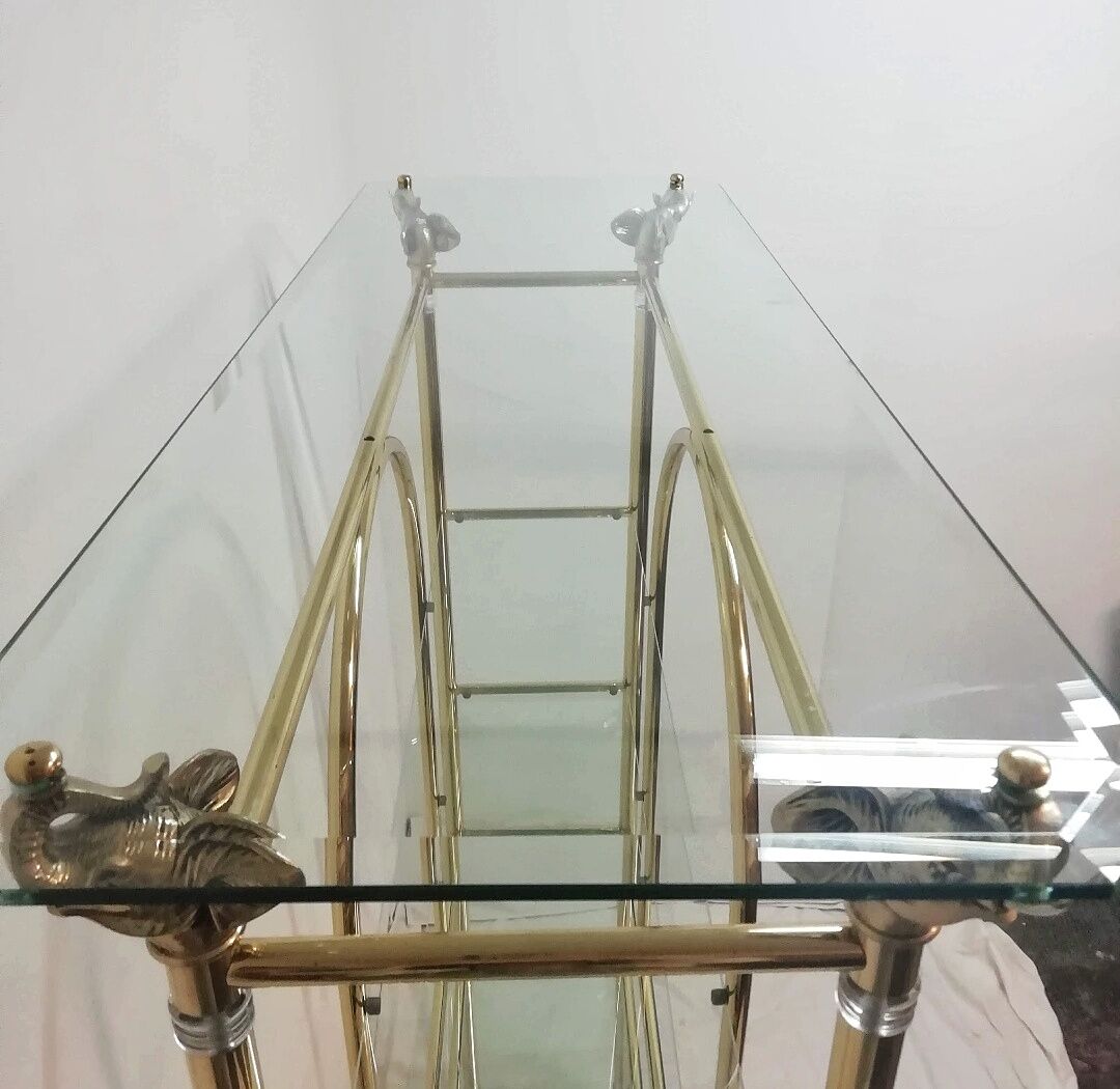 Hollywood Regency brass and glass shelf with elephant heads from the 1970s