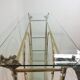 Hollywood Regency brass and glass shelf with elephant heads from the 1970s