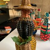 Braided bottle in anthropomorphic wicker