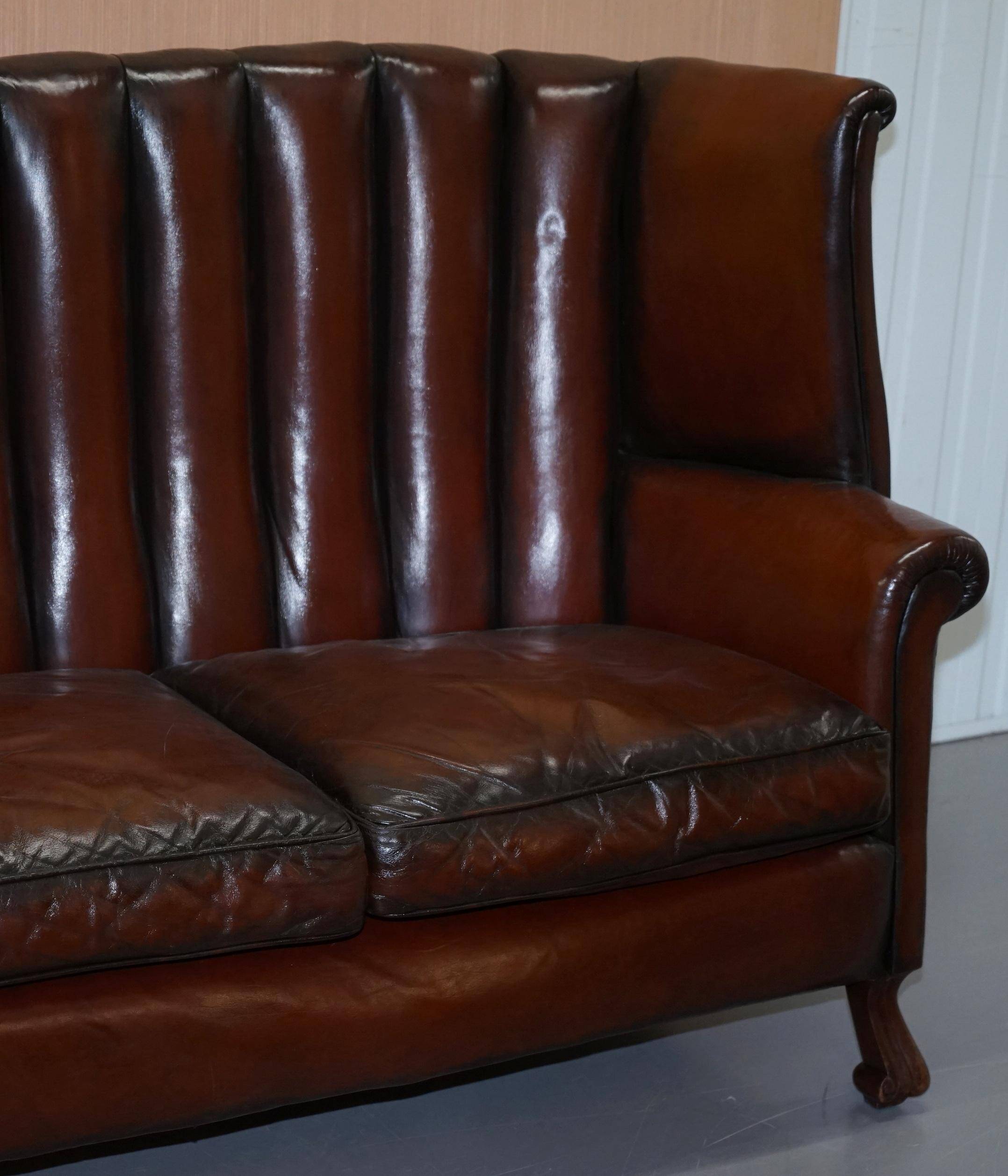 Victorian leather canapé and armchair, barrel back, circa 1860, restored.