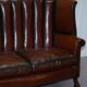 Victorian leather canapé and armchair, barrel back, circa 1860, restored.
