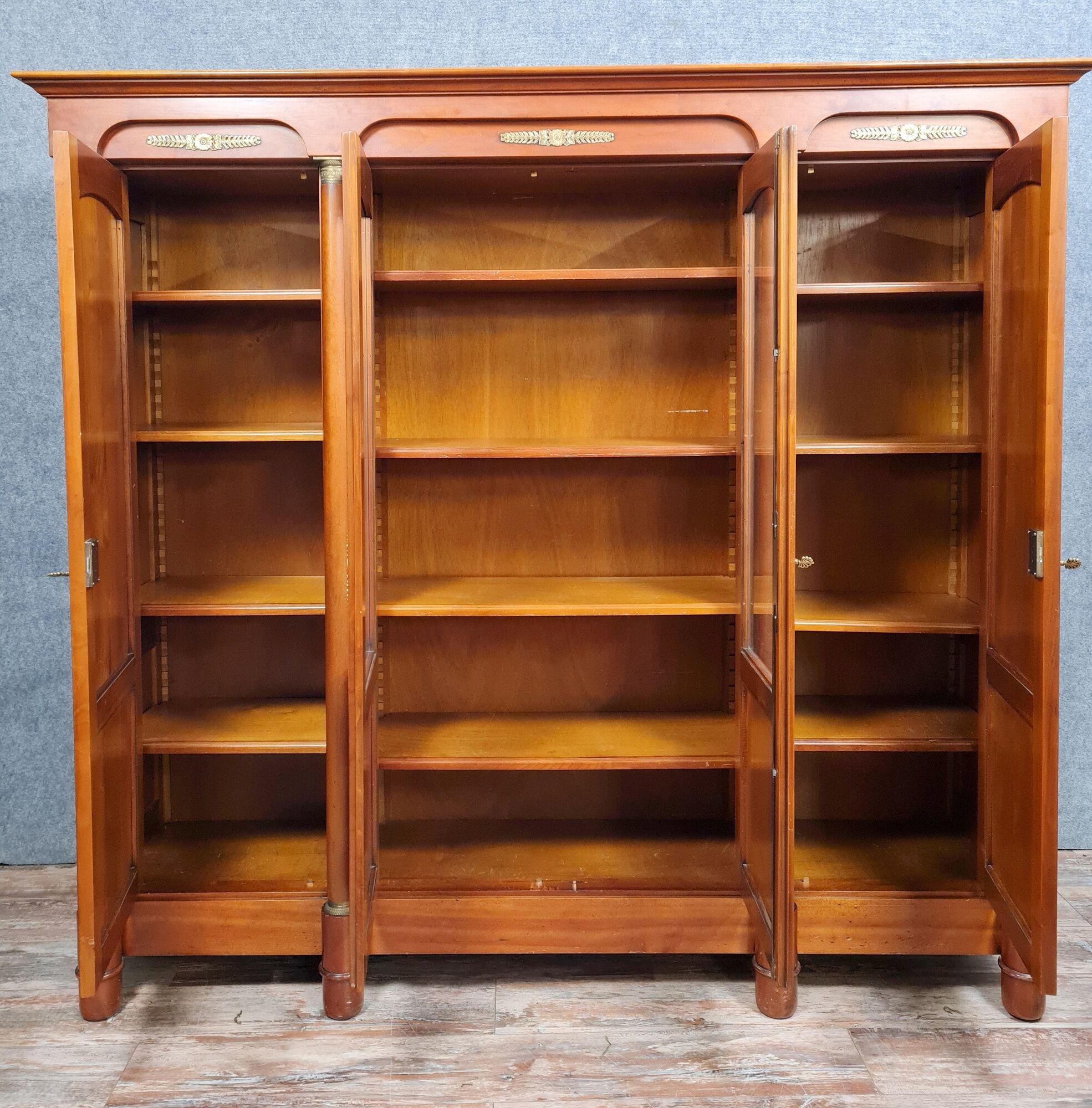 Empire library in cherry tree with blonde patina and gilded bronze around 1950