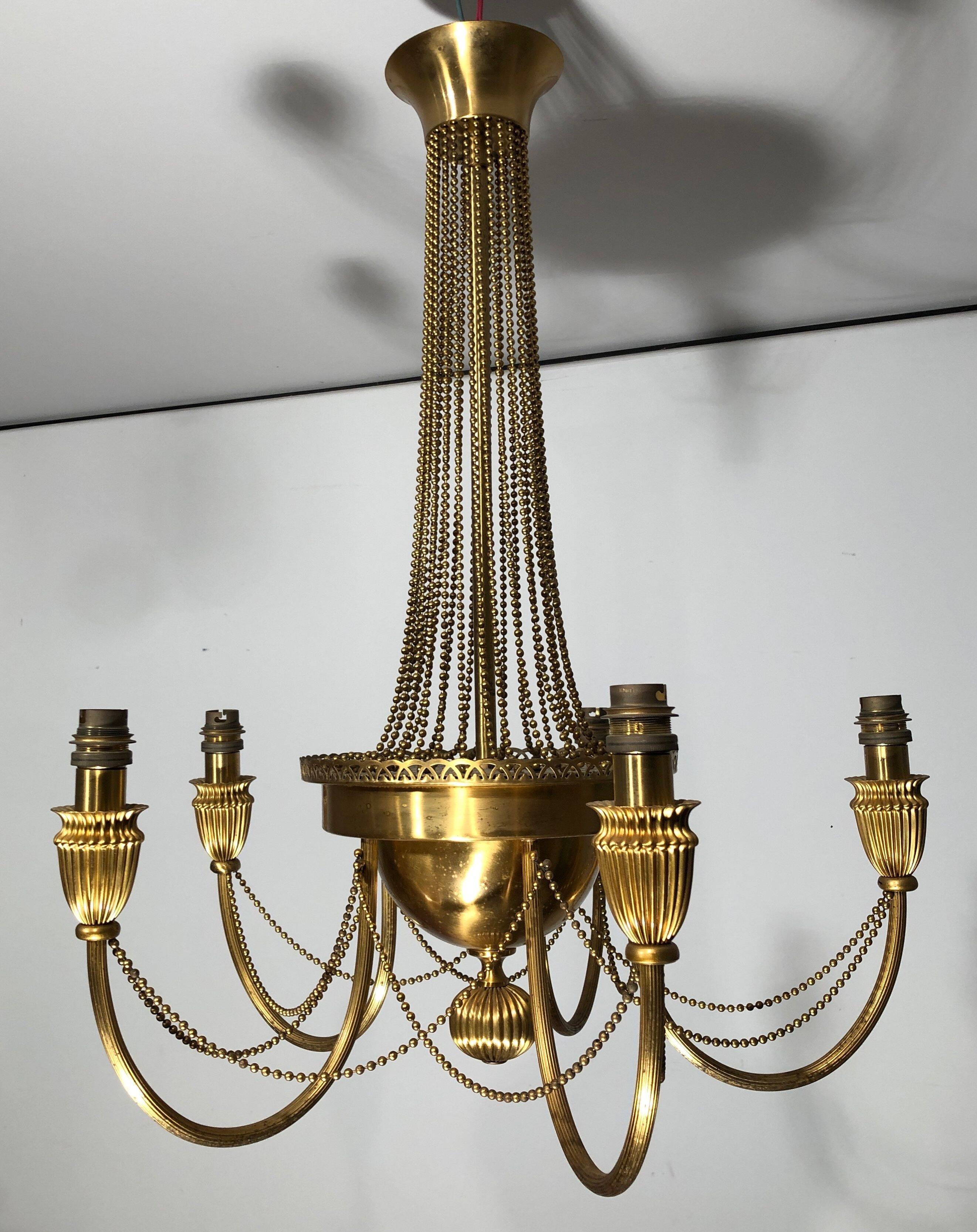 Neoclassical style brass chandelier decorated with pearl garlands