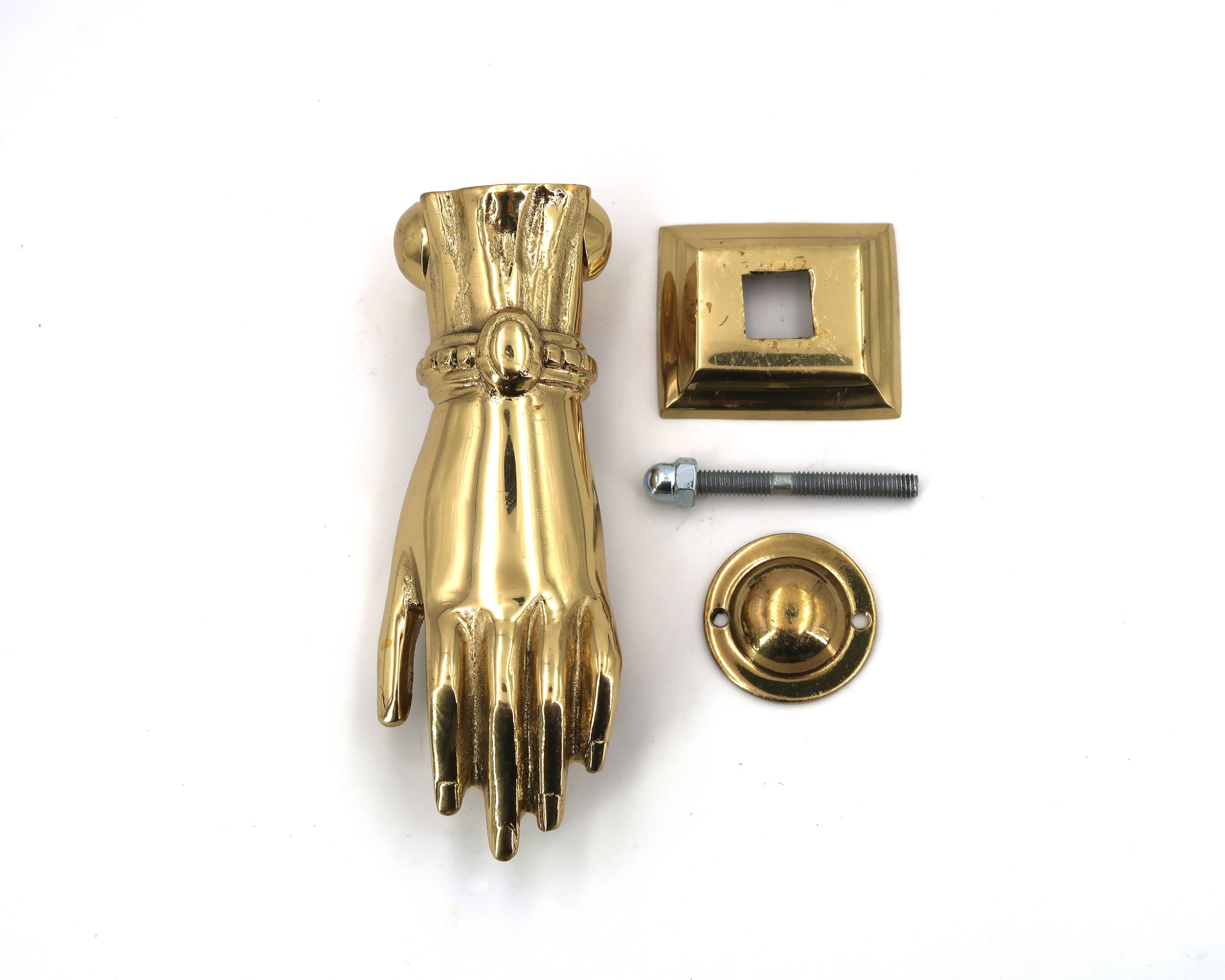Brass door knocker in the shape of a hand, 1970s.