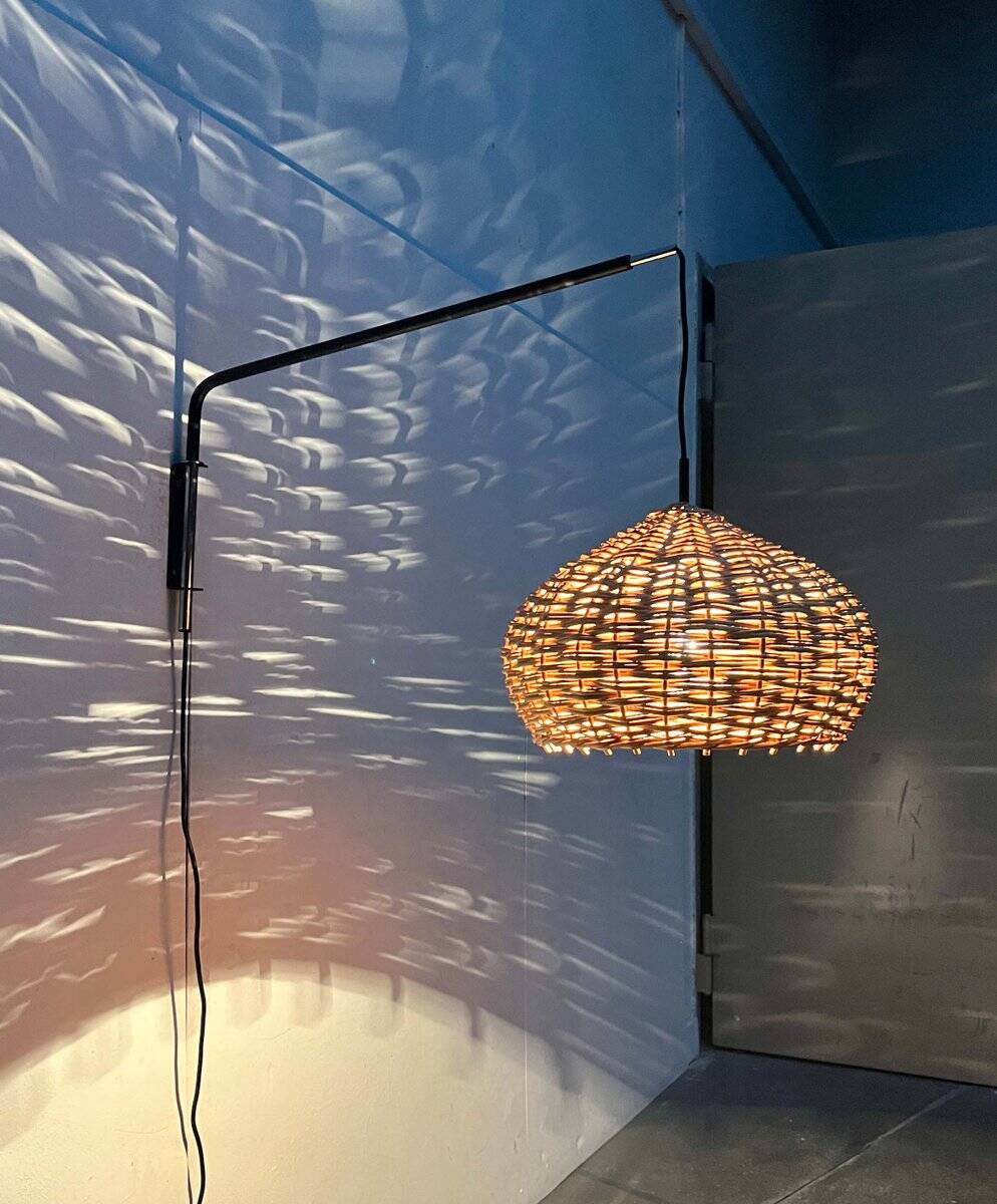 Mid-century modern Danish extendable cantilever wall lamp with a rattan shade, 1960s.