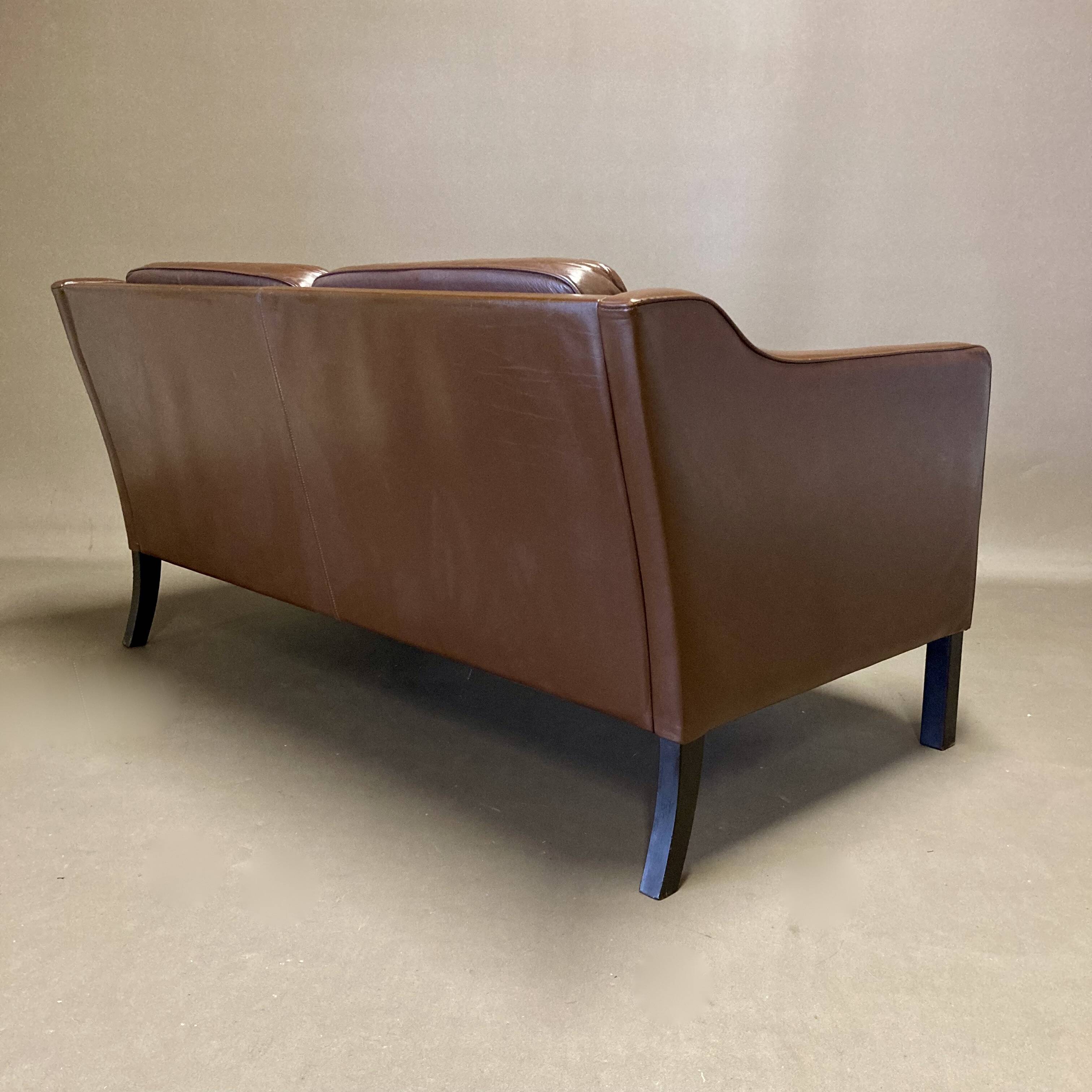 Scandinavian design 2-seater leather sofa.