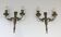 Pair of Louis XVI style wall sconces in bronze with an off-white patina