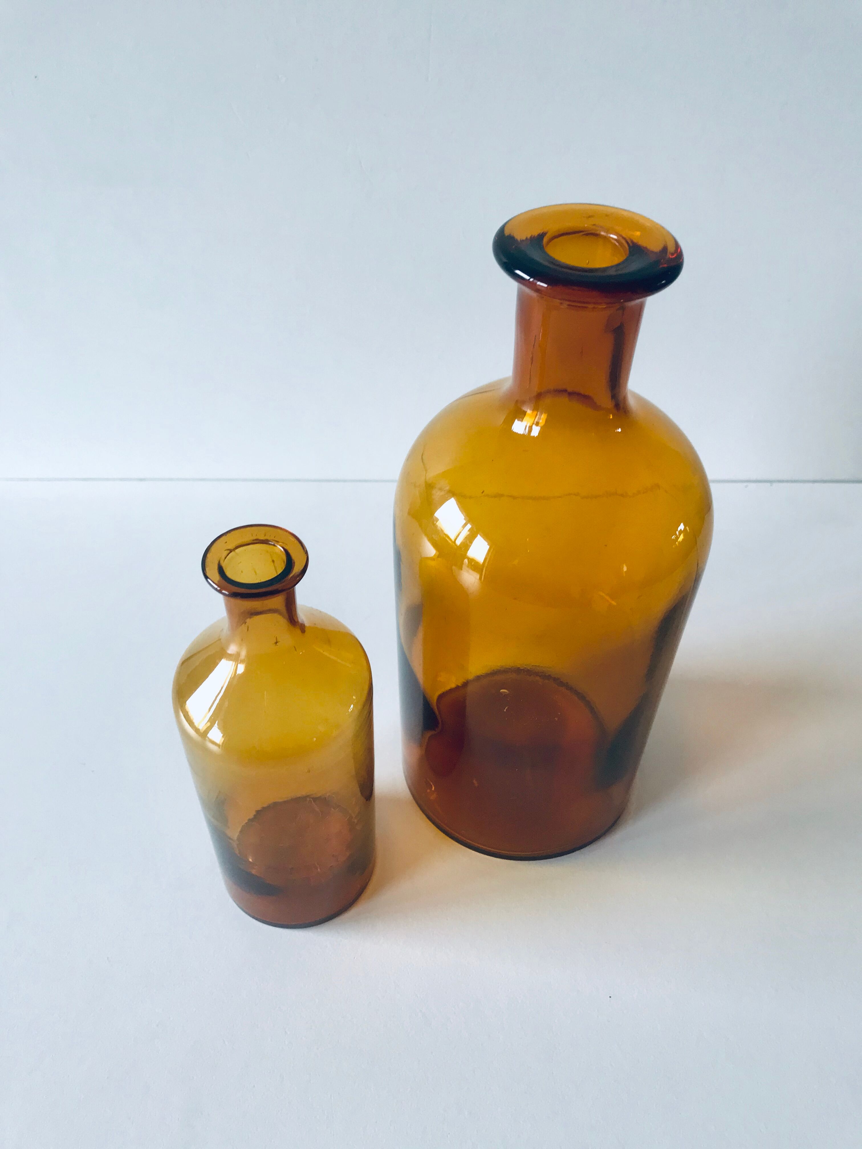 Duo of ancient apothecary flakes in amber glass