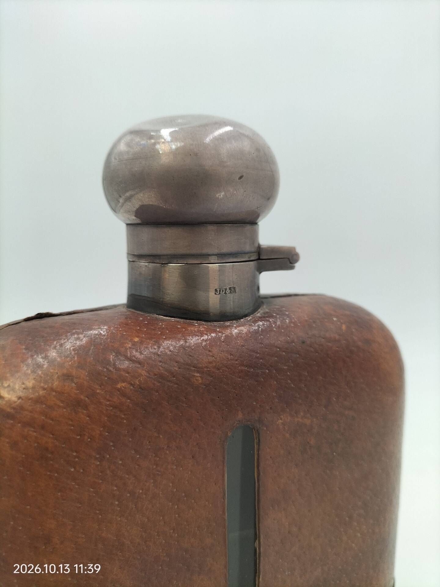 Silver-plated metal flask with leather and glass