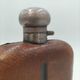 Silver-plated metal flask with leather and glass