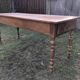 Antique farmhouse table in solid cherry wood with 2 drawers and 1 pull-out at the end with turned legs.