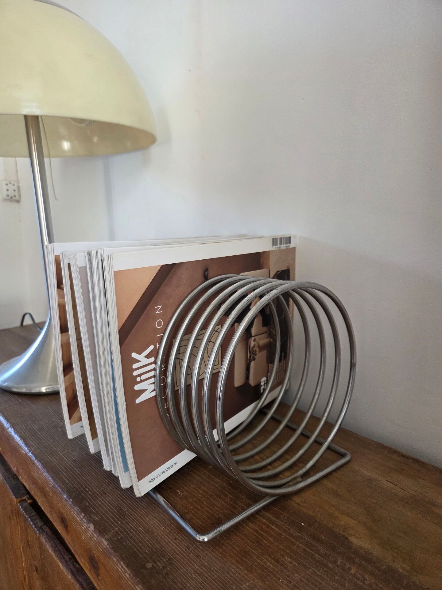 Chrome spring magazine rack, 1970