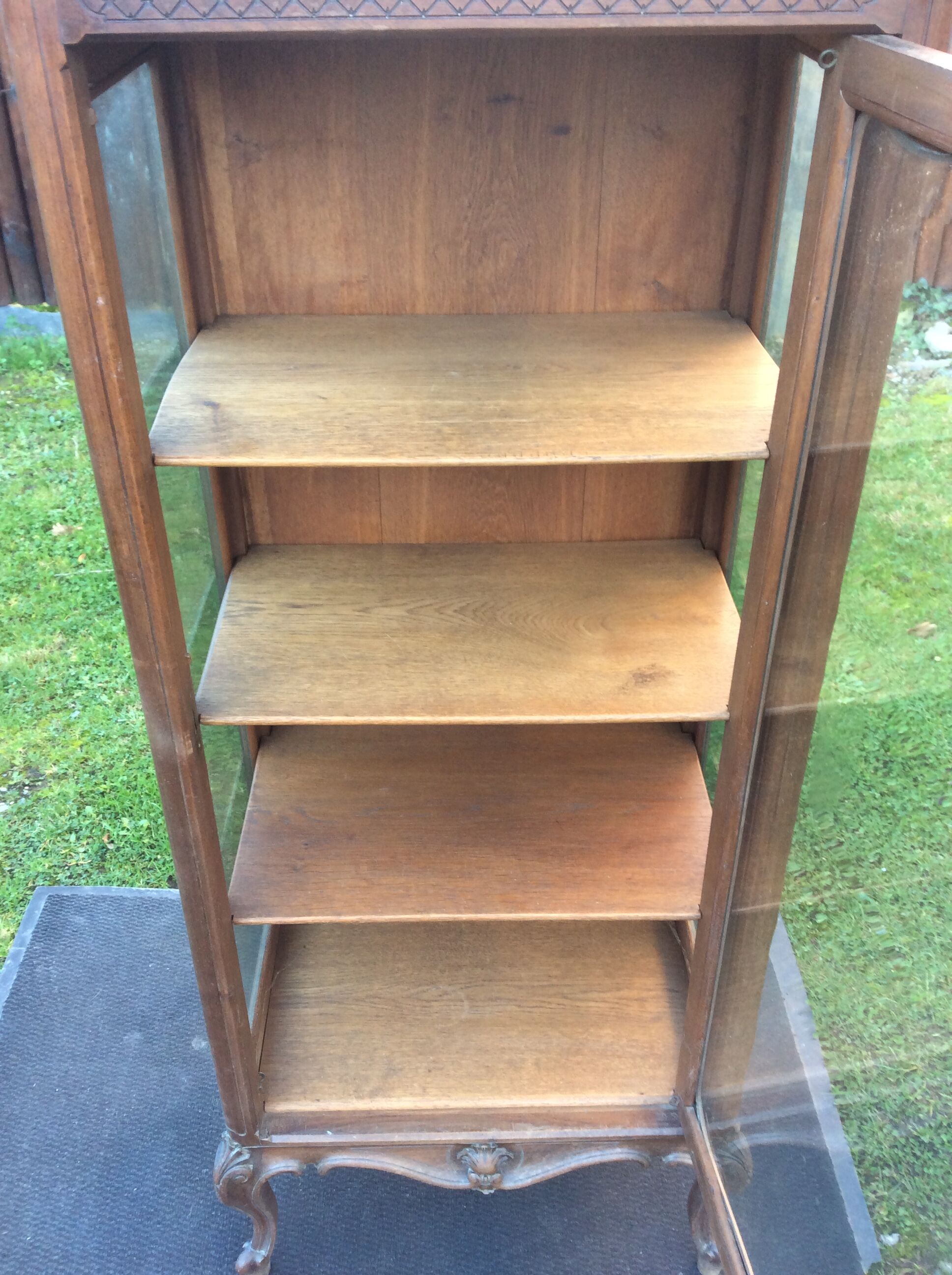 Louis XV Rocaille style showcase in solid walnut, beveled door glass.