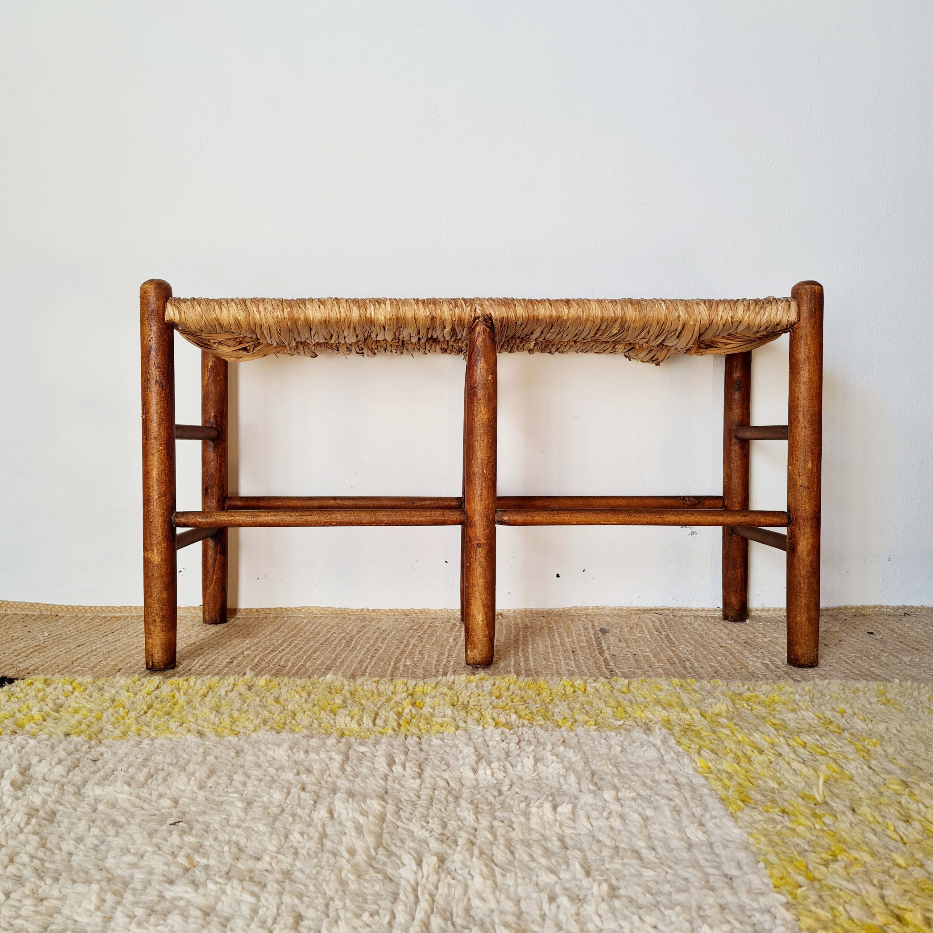 Old wooden and straw bench